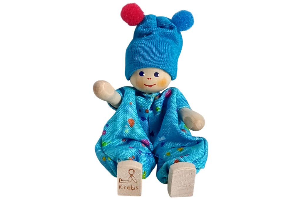 Anne Krebs Miniatur Baby mit Bommelmütze blau