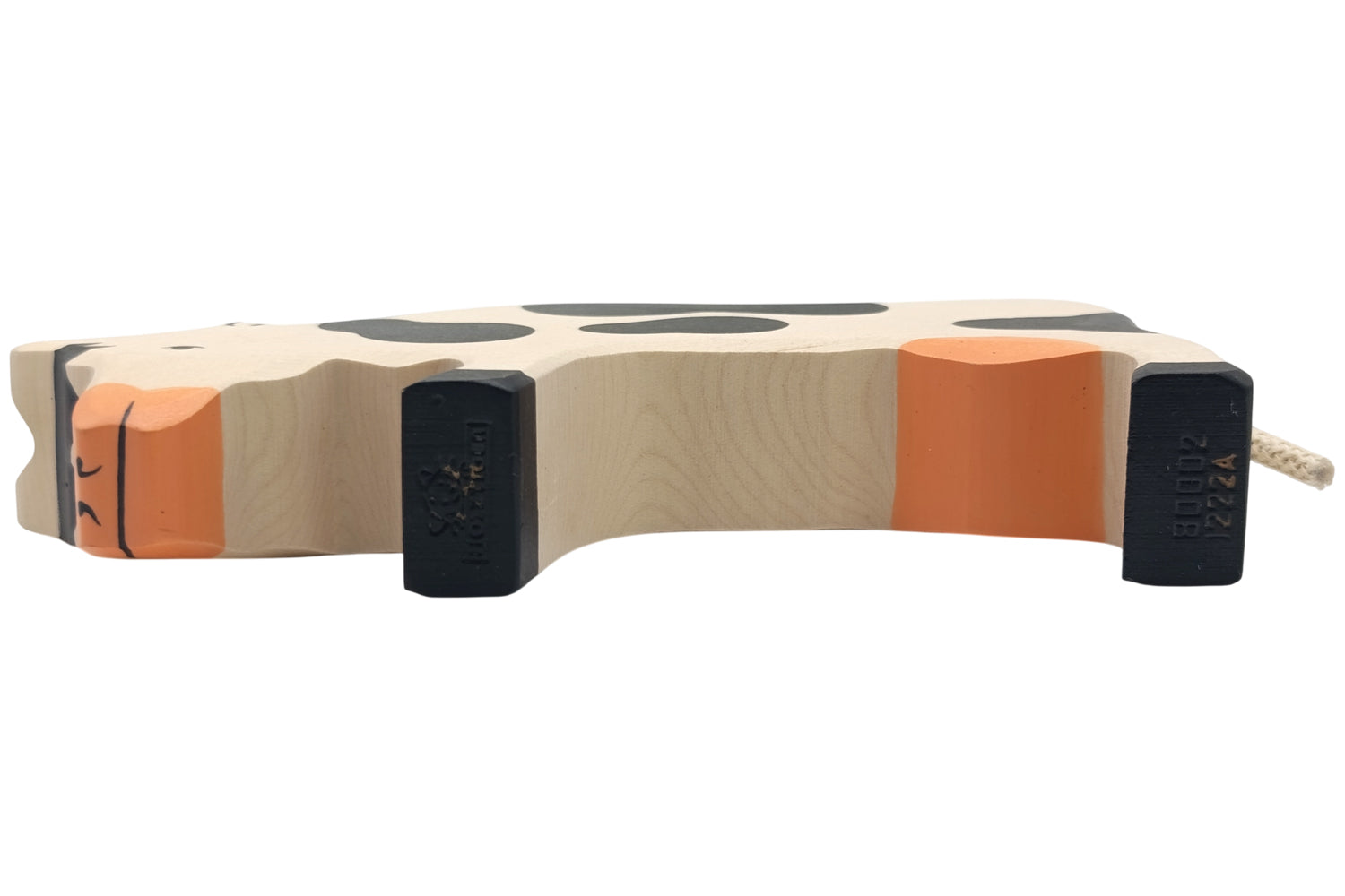 Holztiger Kuh grasend schwarz/weiß
