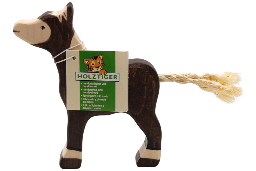 Holztiger Fohlen dunkelbraun stehend
